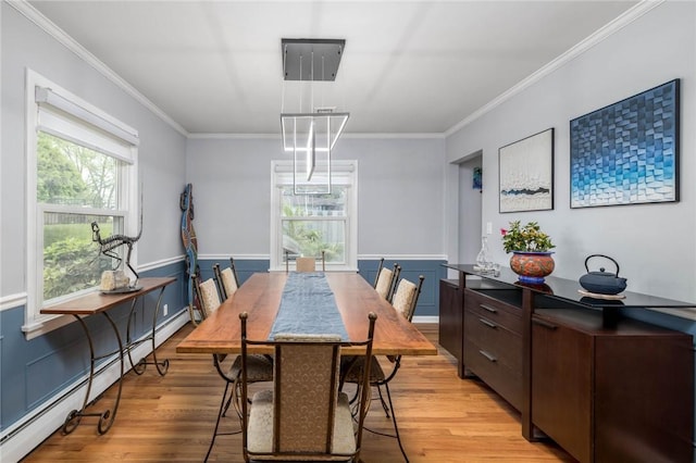 537 Center Church Rd, Peters Twp, PA 15317 - dining area featuring baseboard heating, ornamental molding, light wood-type flooring, and wainscoting