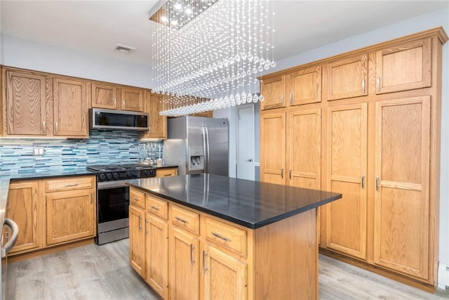 537 Center Church Rd, Peters Twp, PA 15317 - kitchen featuring stainless steel appliances, dark countertops, light wood-type flooring, a chandelier, and backsplash