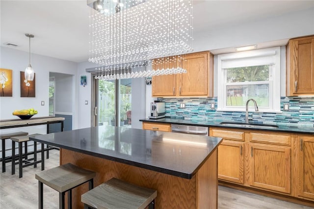 537 Center Church Rd, Peters Twp, PA 15317 - kitchen with dark countertops, light wood-type flooring, backsplash, a breakfast bar area, and dishwasher