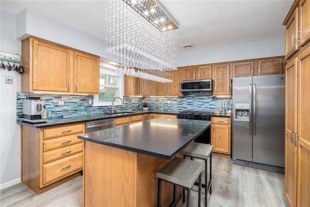 537 Center Church Rd, Peters Twp, PA 15317 - kitchen with appliances with stainless steel finishes, a chandelier, light wood-style floors, and dark countertops