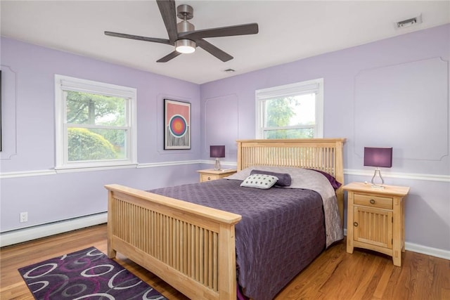 537 Center Church Rd, Peters Twp, PA 15317 - bedroom with a baseboard heating unit, wood finished floors, and a ceiling fan