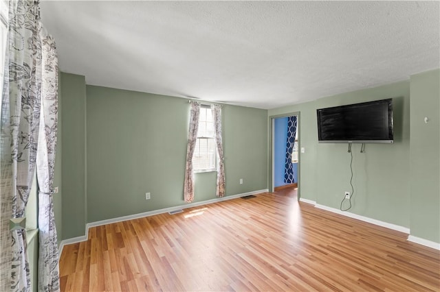 25 Iron St, Canonsburg, PA 15317 - spare room featuring light wood-style flooring and a textured ceiling