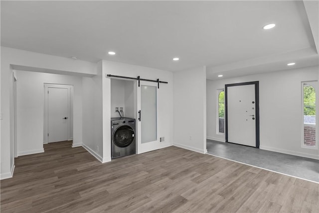 2513 Grove Rd, South Park, PA 15129 - unfurnished living room featuring washer / dryer, a barn door, recessed lighting, and wood finished floors