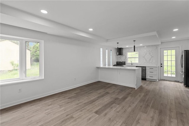 2513 Grove Rd, South Park, PA 15129 - kitchen with stainless steel appliances, recessed lighting, wood finished floors, light countertops, and a peninsula