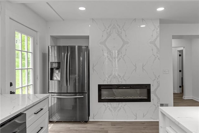 2513 Grove Rd, South Park, PA 15129 - kitchen featuring stainless steel fridge, light stone counters, white cabinetry, light wood-style flooring, and recessed lighting