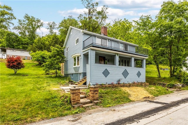 2513 Grove Rd, South Park, PA 15129 - view of front facade featuring a balcony, a chimney, and a front yard
