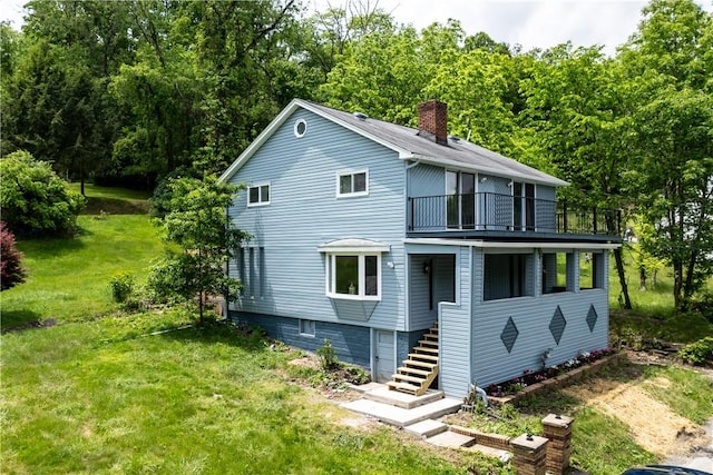 2513 Grove Rd, South Park, PA 15129 - rear view of house featuring a balcony, a lawn, a chimney, and stairway