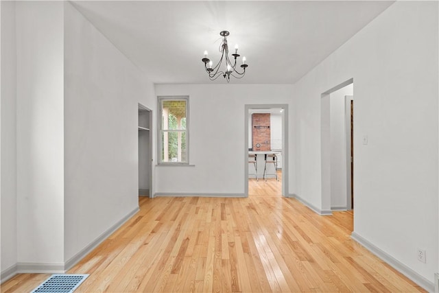 841 Stanton Ave, Millvale, PA 15209 - unfurnished dining area featuring a chandelier and light wood finished floors