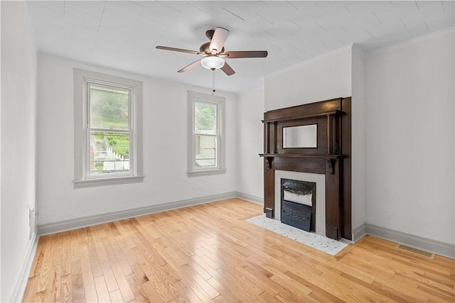 841 Stanton Ave, Millvale, PA 15209 - unfurnished living room featuring wood finished floors, a fireplace with flush hearth, ceiling fan, and ornamental molding
