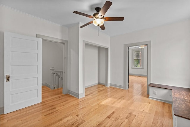 841 Stanton Ave, Millvale, PA 15209 - unfurnished bedroom with light wood-style flooring, crown molding, ceiling fan, and a closet