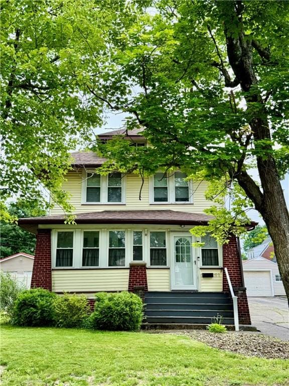91 Wick Ave, Hermitage, PA 16148 - american foursquare style home with a detached garage, a front lawn, and brick siding