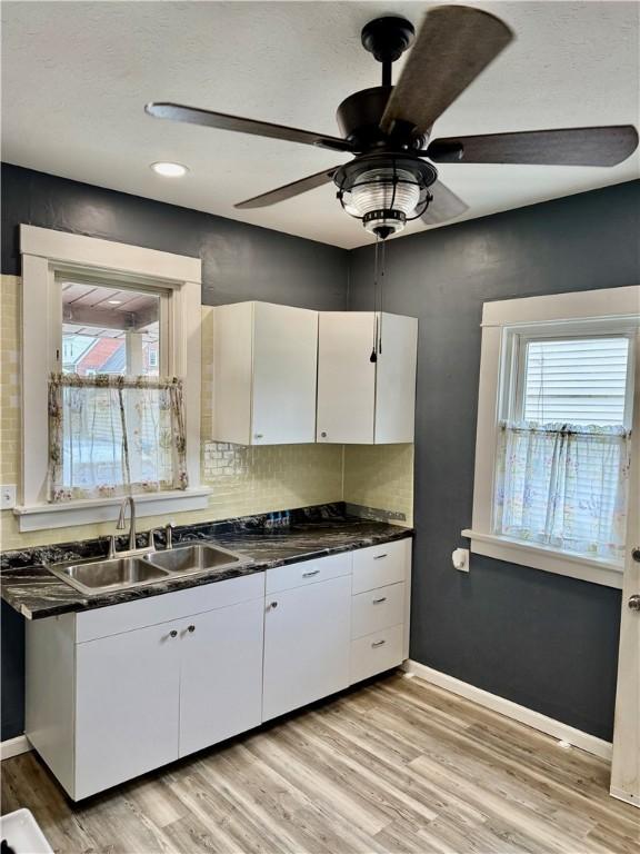 91 Wick Ave, Hermitage, PA 16148 - kitchen featuring white cabinetry, dark countertops, ceiling fan, and light wood-style flooring