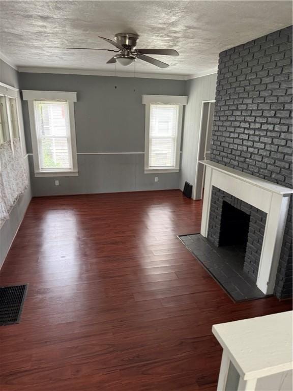 91 Wick Ave, Hermitage, PA 16148 - unfurnished living room featuring ceiling fan, plenty of natural light, wood finished floors, a textured ceiling, and a fireplace