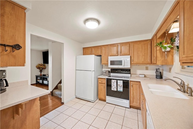 524 Sandy Hill Rd, Manor, PA 15642 - kitchen with white appliances, light countertops, light tile patterned floors, and brown cabinets