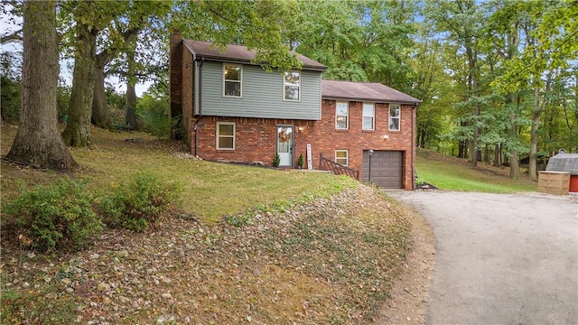 524 Sandy Hill Rd, Manor, PA 15642 - split level home featuring driveway, a garage, a chimney, brick siding, and a front yard