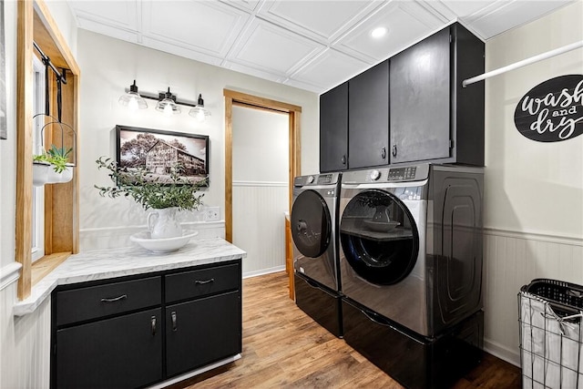 260 Stouffer Hill Rd, Somerset Twp, PA 15541 - laundry room featuring washer and clothes dryer, cabinet space, wood finished floors, and wainscoting
