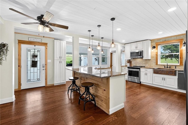 260 Stouffer Hill Rd, Somerset Twp, PA 15541 - kitchen with appliances with stainless steel finishes, dark wood finished floors, dark stone counters, and recessed lighting