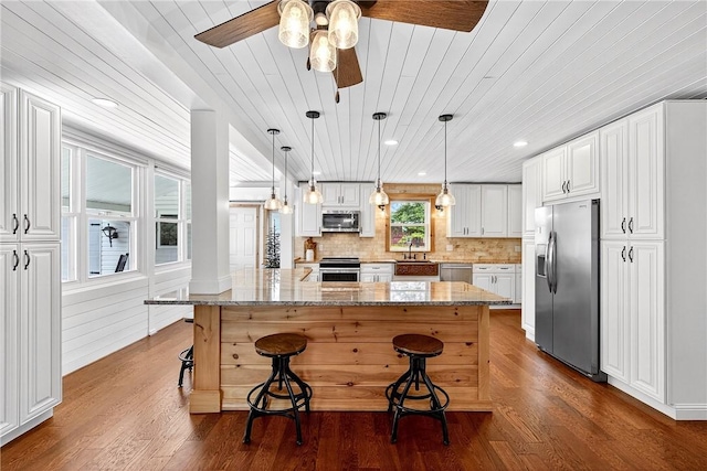 260 Stouffer Hill Rd, Somerset Twp, PA 15541 - kitchen featuring appliances with stainless steel finishes, wood ceiling, a breakfast bar area, a ceiling fan, and white cabinets