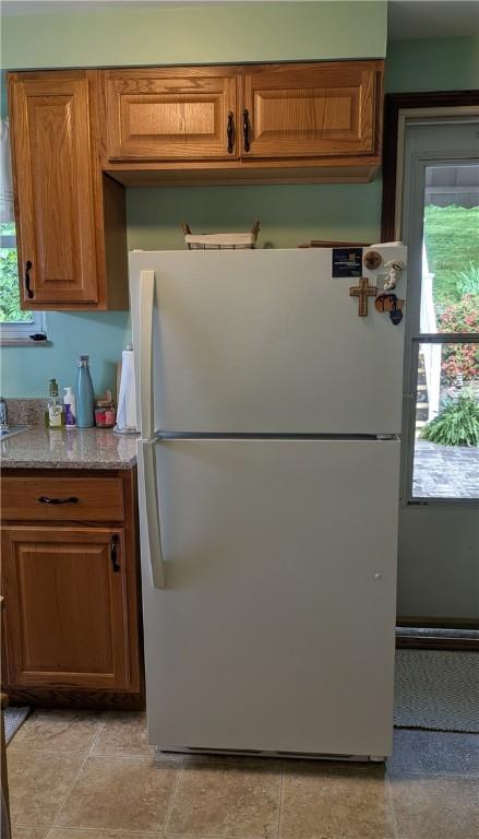 218 Bascom, Observatory Hill, PA 15214 - kitchen with freestanding refrigerator, brown cabinets, and light stone countertops