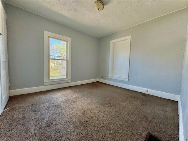 420 Reed St, Sharon, PA 16146 - spare room with a textured ceiling and dark carpet