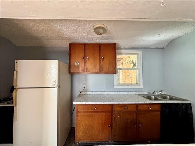 420 Reed St, Sharon, PA 16146 - kitchen featuring freestanding refrigerator, light countertops, and brown cabinetry