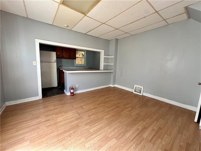 420 Reed St, Sharon, PA 16146 - unfurnished living room featuring a paneled ceiling and light wood-type flooring