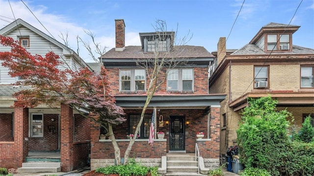 22 Beltzhoover Ave, Allentown, PA 15210 - traditional style home featuring covered porch, a chimney, brick siding, and cooling unit