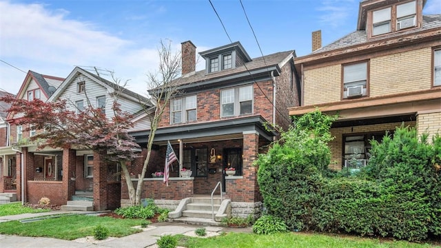 22 Beltzhoover Ave, Allentown, PA 15210 - traditional style home featuring brick siding, covered porch, a chimney, and cooling unit