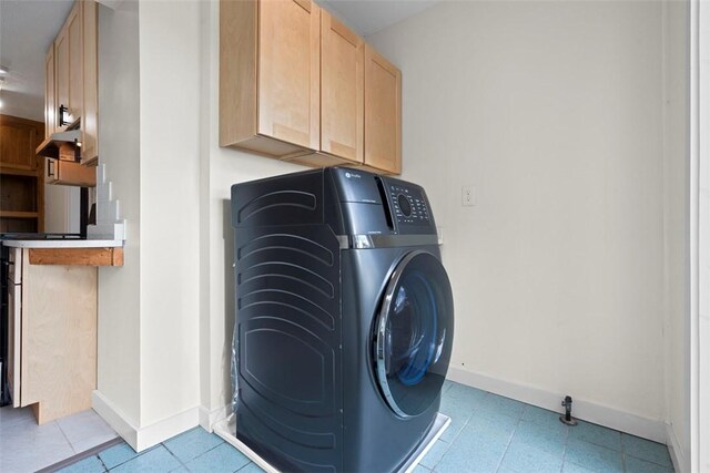 22 Beltzhoover Ave, Allentown, PA 15210 - laundry room with washer / dryer, light tile patterned flooring, and cabinet space