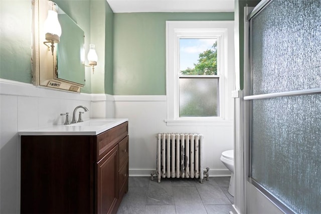 22 Beltzhoover Ave, Allentown, PA 15210 - full bath featuring radiator, vanity, wainscoting, an enclosed shower, and a decorative wall