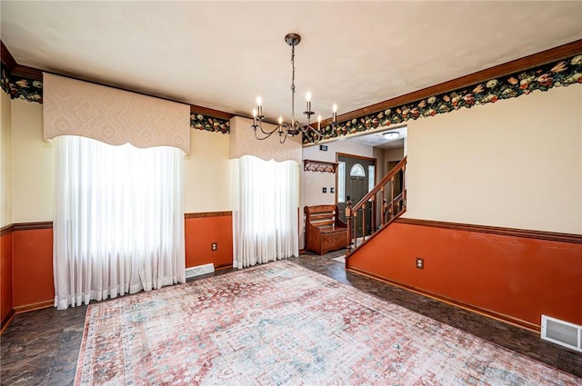4025 Holiday Park Dr, Murrysville, PA 15668 - unfurnished dining area featuring plenty of natural light, a chandelier, stairs, stone finish flooring, and a wainscoted wall