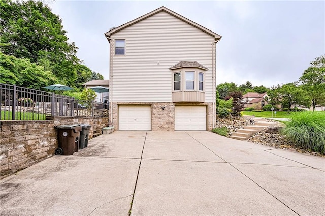 4025 Holiday Park Dr, Murrysville, PA 15668 - view of side of property featuring brick siding, a garage, and concrete driveway