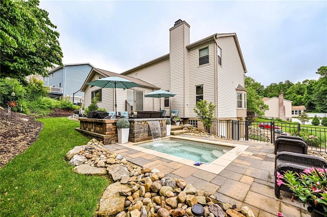 4025 Holiday Park Dr, Murrysville, PA 15668 - rear view of house with an outdoor hot tub, a patio, and a chimney