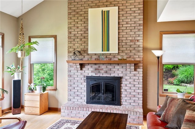 2507 Sarah Ct, Murrysville, PA 15668 - living area featuring wood finished floors, lofted ceiling, and a brick fireplace