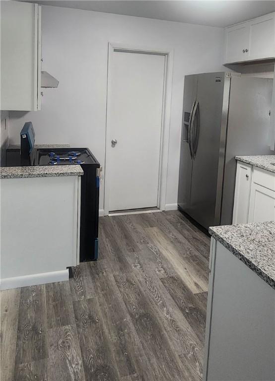 118 Brady Ave, City Of Washington, PA 15301 - kitchen with dark wood-style floors, white cabinets, stainless steel fridge with ice dispenser, stove, and light stone countertops