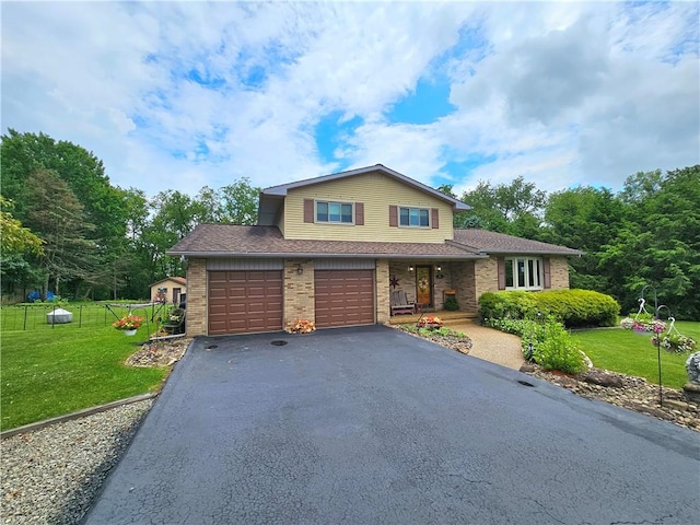 15 Pineview Ests, Sewickley Twp, PA 15089 - view of front of house with a front yard, asphalt driveway, brick siding, and an attached garage