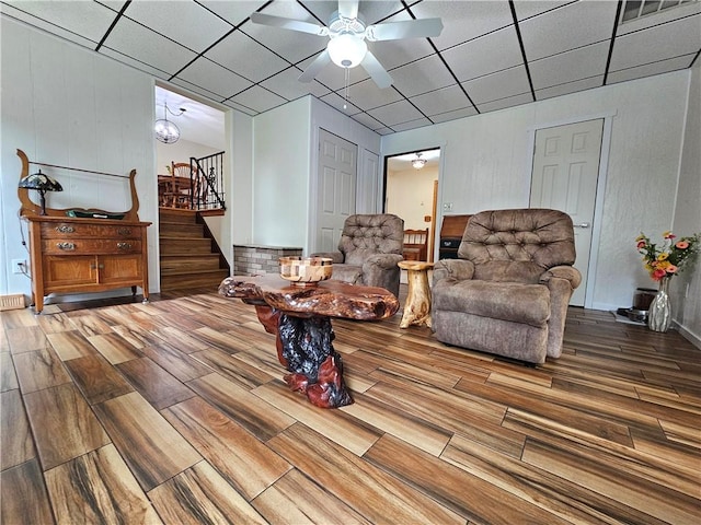15 Pineview Ests, Sewickley Twp, PA 15089 - living area featuring wood finished floors, stairway, ceiling fan, and a drop ceiling
