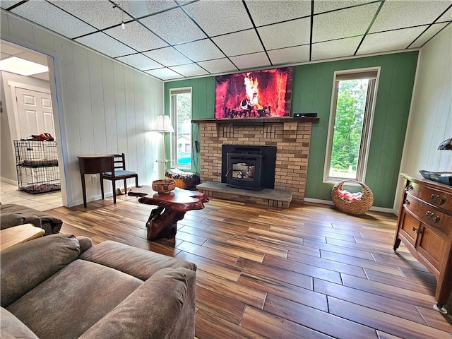 15 Pineview Ests, Sewickley Twp, PA 15089 - living area featuring wood finished floors, a paneled ceiling, a brick fireplace, and wood walls