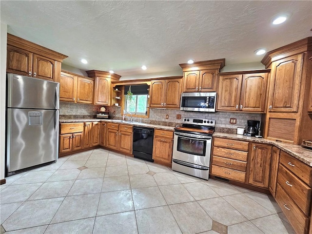 15 Pineview Ests, Sewickley Twp, PA 15089 - kitchen with stainless steel appliances, brown cabinets, decorative backsplash, light tile patterned floors, and recessed lighting
