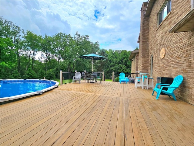 15 Pineview Ests, Sewickley Twp, PA 15089 - wooden deck featuring an outdoor pool, outdoor dining space, and view of scattered trees