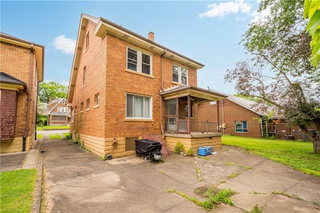 1223 Ingham St, Marshall Shadeland, PA 15212 - back of property featuring brick siding, a chimney, a lawn, and a patio area