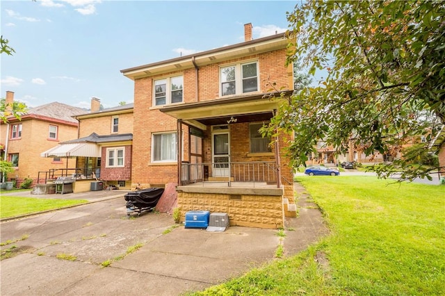1223 Ingham St, Marshall Shadeland, PA 15212 - rear view of house featuring brick siding, a lawn, and a chimney