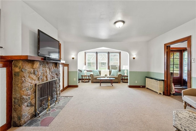 1223 Ingham St, Marshall Shadeland, PA 15212 - carpeted living area featuring radiator, arched walkways, and a fireplace