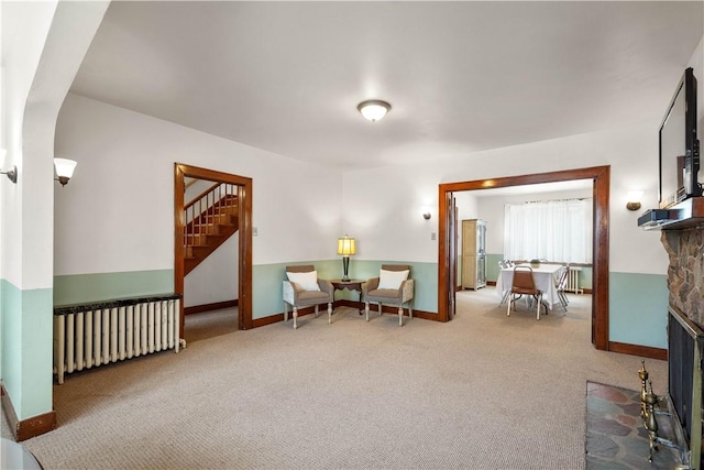 1223 Ingham St, Marshall Shadeland, PA 15212 - sitting room with radiator heating unit, a stone fireplace, stairs, carpet floors, and arched walkways