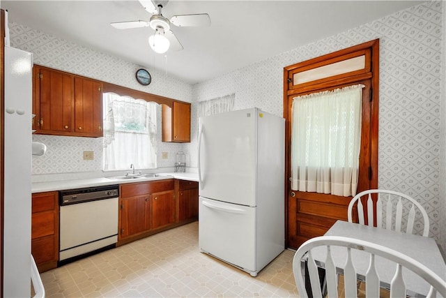 1223 Ingham St, Marshall Shadeland, PA 15212 - kitchen with white appliances, wallpapered walls, light countertops, ceiling fan, and brown cabinets