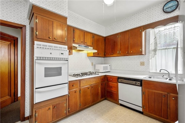 1223 Ingham St, Marshall Shadeland, PA 15212 - kitchen featuring white appliances, a warming drawer, wallpapered walls, under cabinet range hood, and brown cabinetry