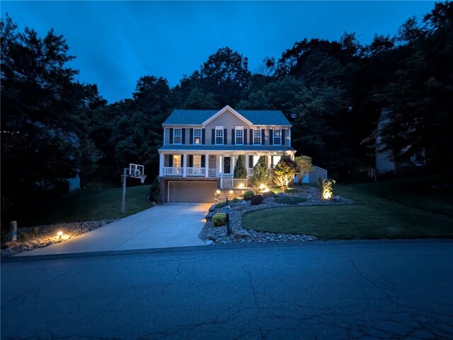 54 Colony Oaks Dr, Shaler, PA 15209 - colonial inspired home featuring a porch, a front yard, concrete driveway, and a garage