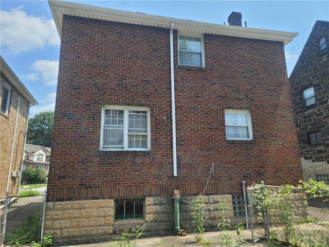5510 Pocusset St, Squirrel Hill, PA 15217 - view of side of home featuring brick siding and a chimney