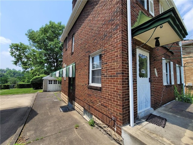 5510 Pocusset St, Squirrel Hill, PA 15217 - view of side of home featuring brick siding, an outbuilding, and a garage