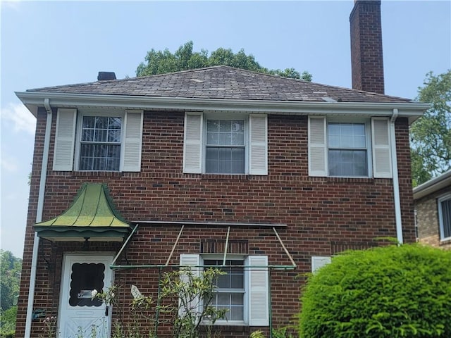 5510 Pocusset St, Squirrel Hill, PA 15217 - view of front of property featuring brick siding and a chimney